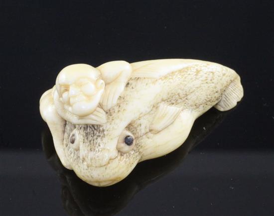 A Japanese ivory netsuke of a man riding an earthquake fish, Edo period, 4.7cm